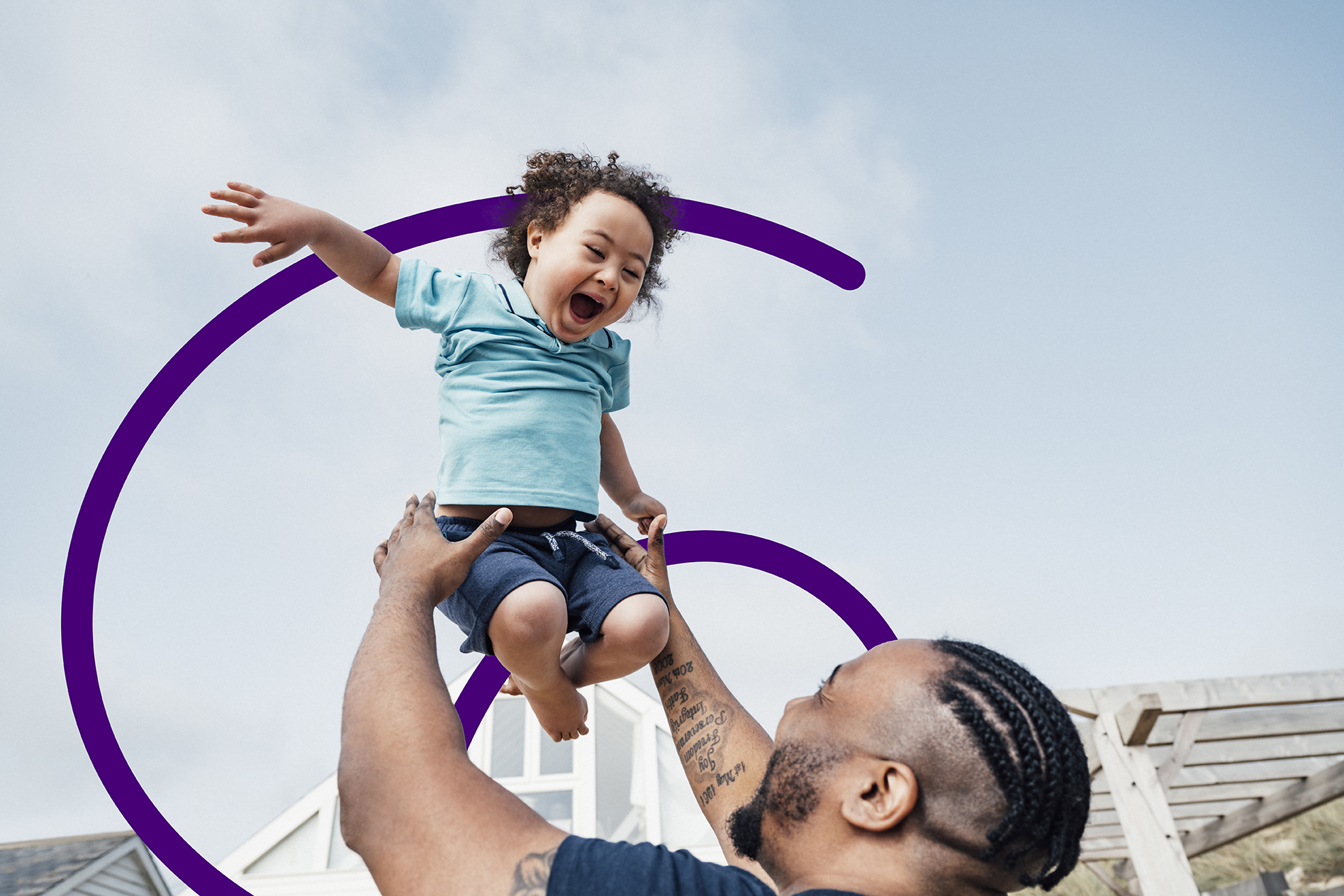 Man lifting child into the air